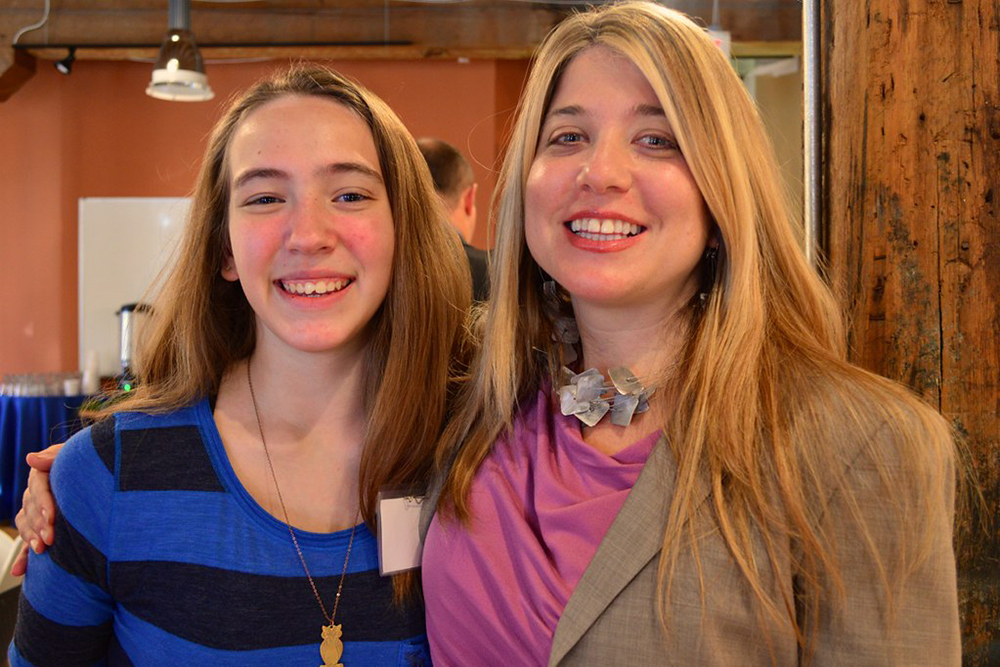 Stacie Sanders Evans posing for a photo with Colette, a high school student and Impact Breakfast speaker